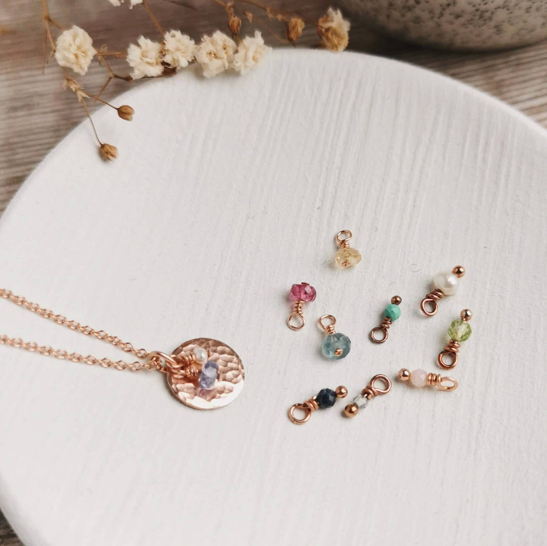 rose gold birthstone necklace with a group of gemstones for all different month's birthstones