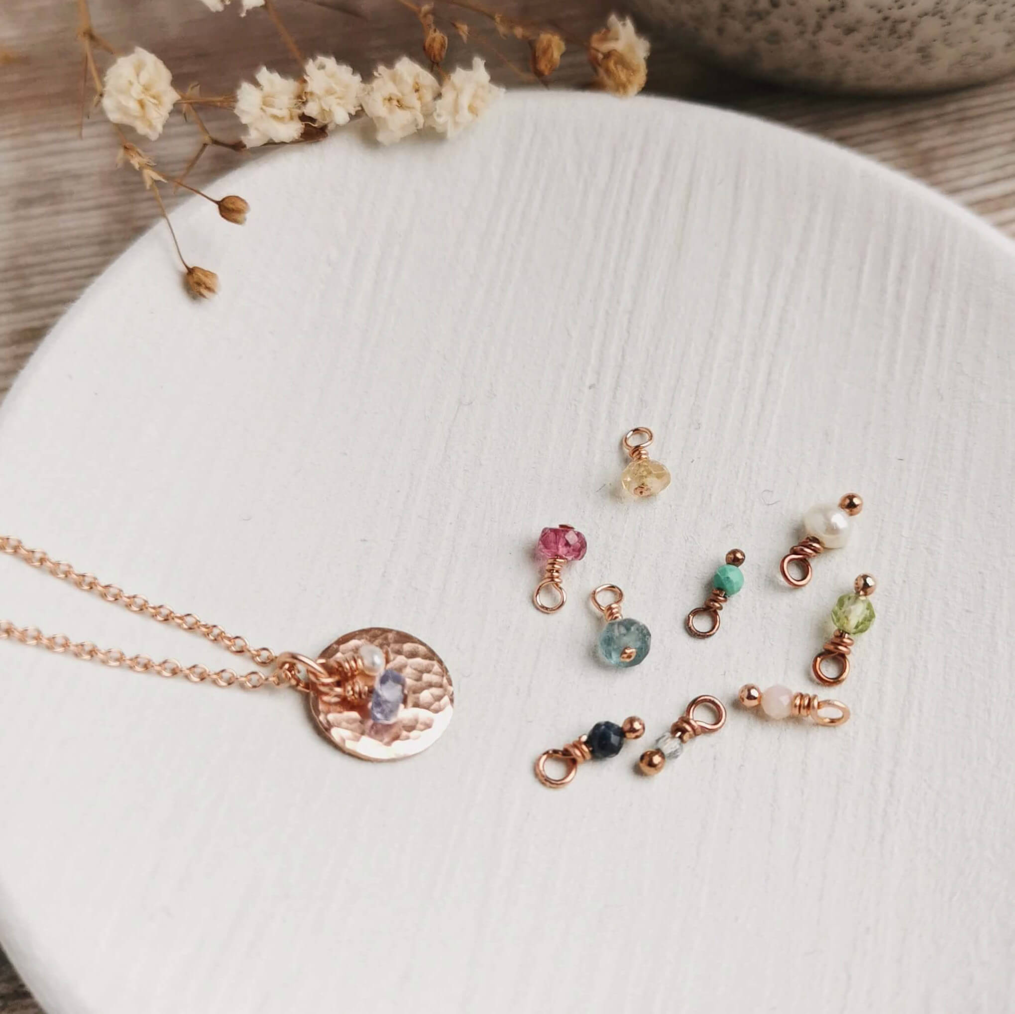 rose gold birthstone necklace with a group of gemstones for all different month's birthstones