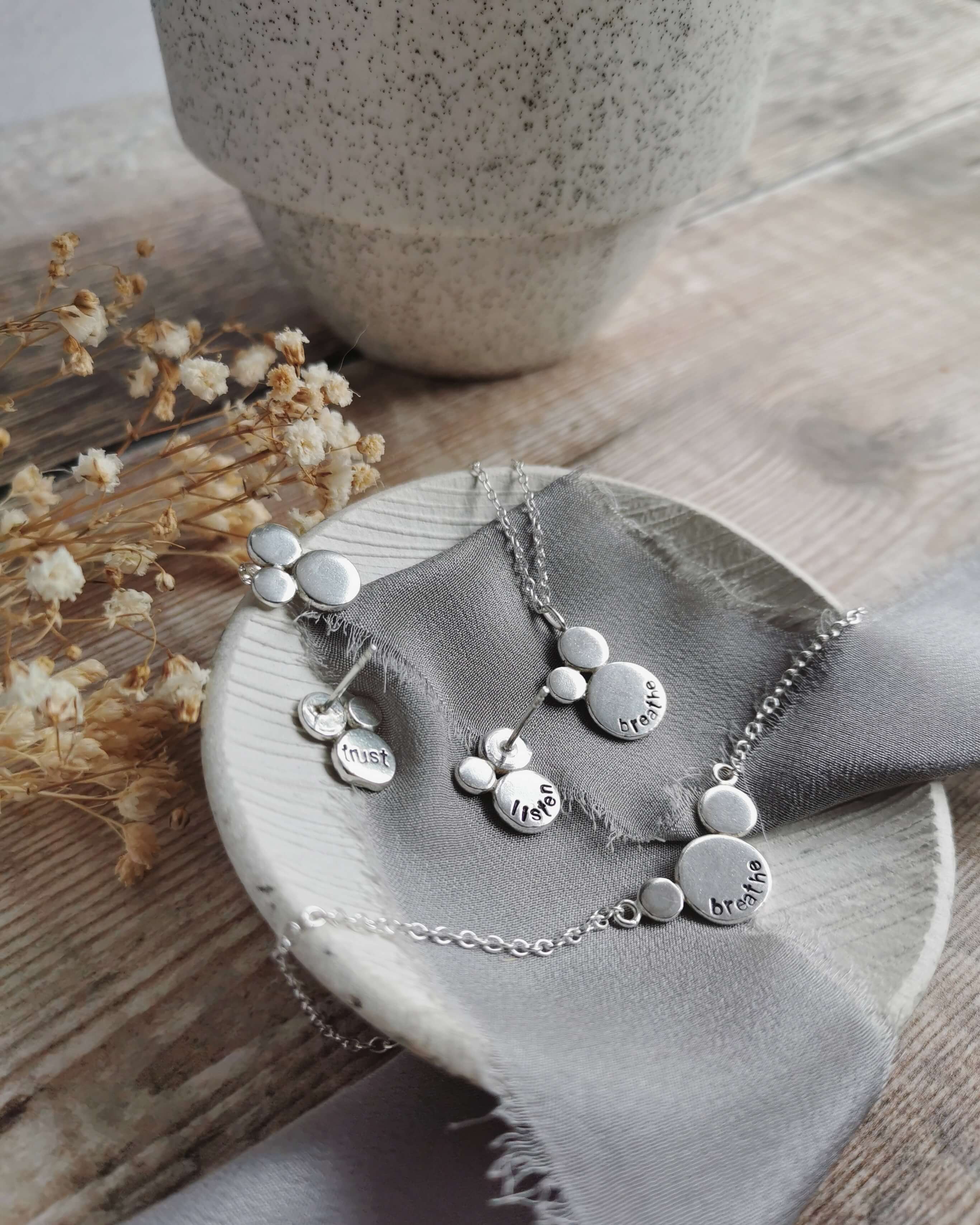 recycled silver necklaces and stud earrings with hand stamped words as a personal mantra