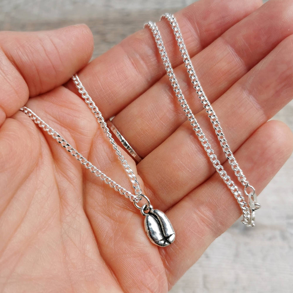 Men's jewellery gift idea - silver curb chain with silver coffee bean charm held in hand