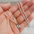 Men's jewellery gift idea - silver curb chain with silver coffee bean charm held in hand