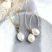 Pearl and gold necklace and earrings on a textured surface with a soft background
