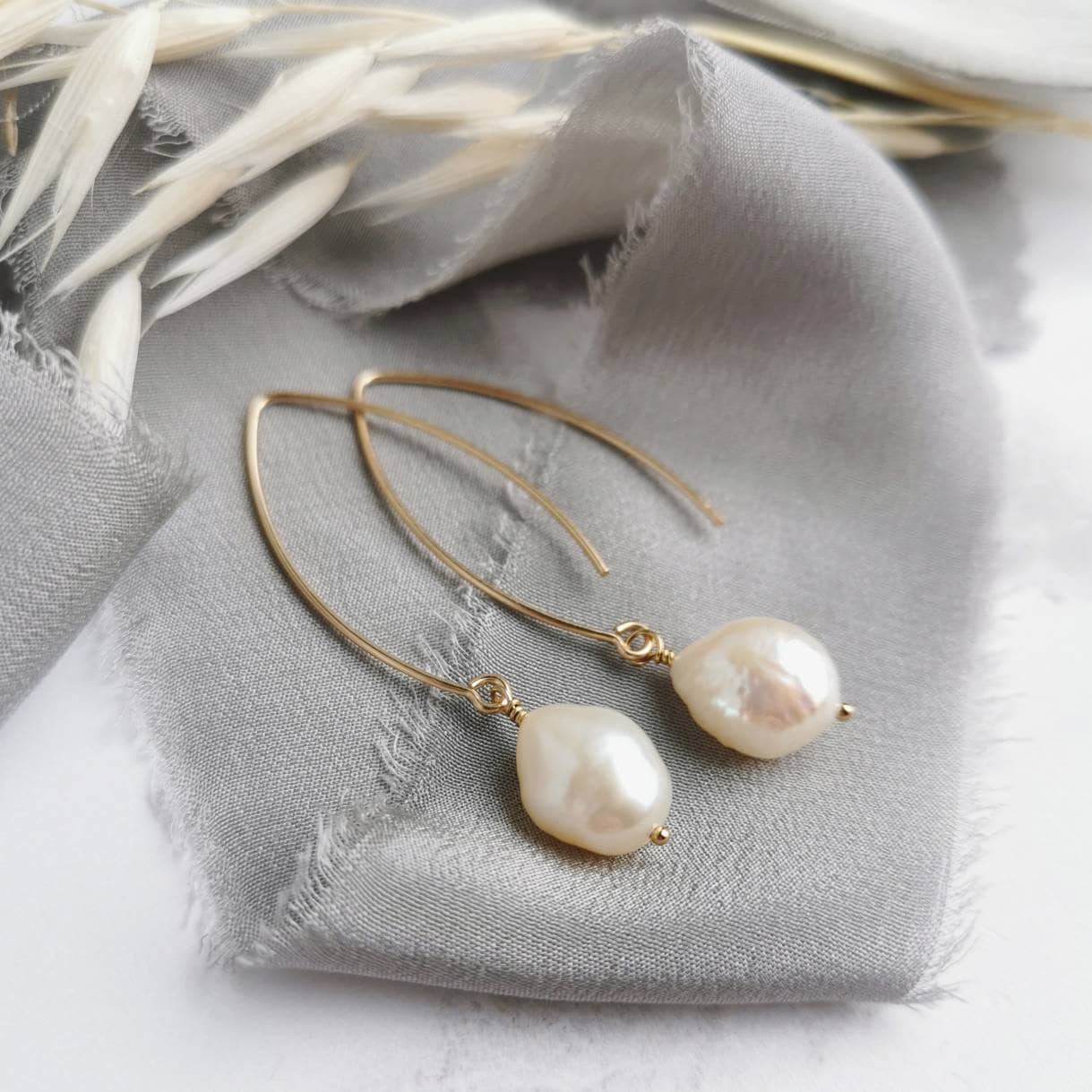 ivory baroque pearl earrings with 14k gold-filled handmade earwires on a grey silk background