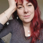 Cat Birch, a red haired young woman, wearing the silver birch leaf collection - handmade necklaces and earrings and bangle featuring silver birch leaves