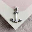 handmade silver anchor charm on a pale pink and cream book cover
