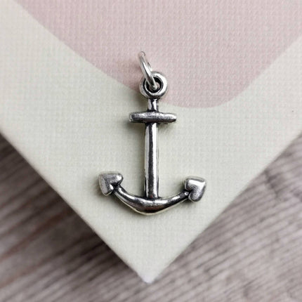 handmade silver anchor charm on a pale pink and cream book cover