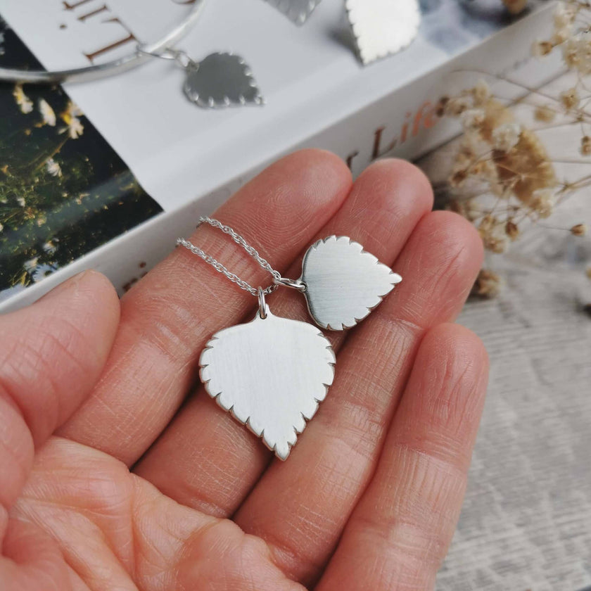 silver birch leaf necklace large and small leaves held in hand